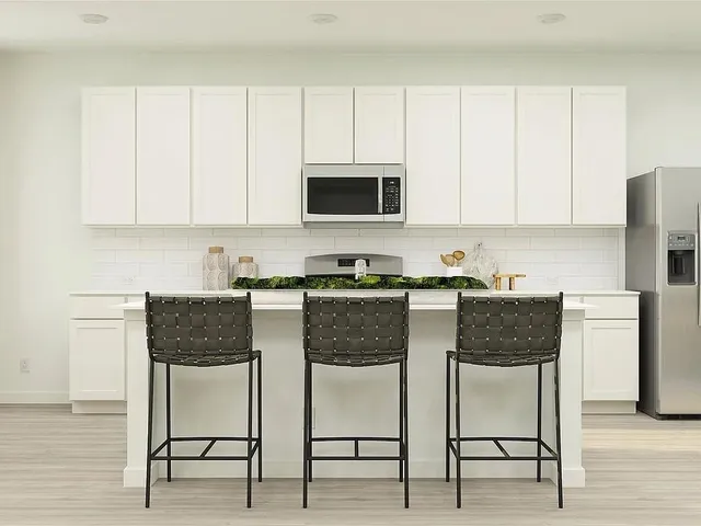 a living room with furniture a large mirror and a table