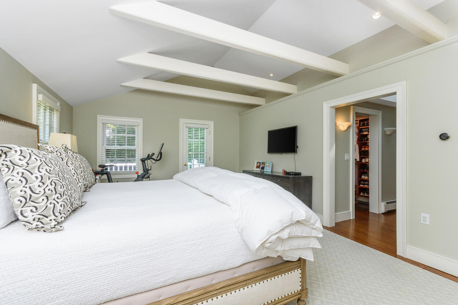 44 Brookside Road Darien, CT 06820 - Photo 22 of 36 a spacious bedroom with a bed and a flat screen tv