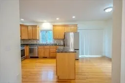 a kitchen with stainless steel appliances granite countertop a refrigerator and a stove