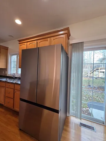 a kitchen with a sink a stove a window and cabinets