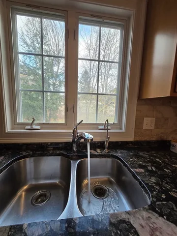 a view of room with window and wooden floor