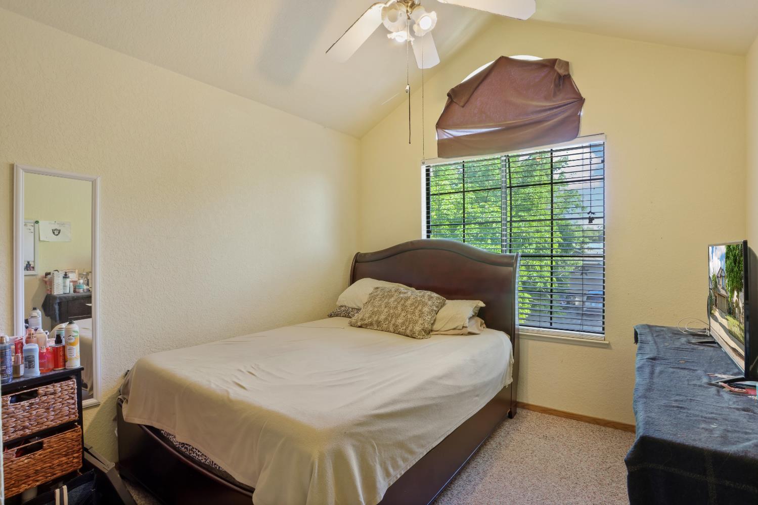 2008 Sheldon Drive Modesto, CA 95350 - Photo 29 of 39 a bedroom with a bed and a chandelier