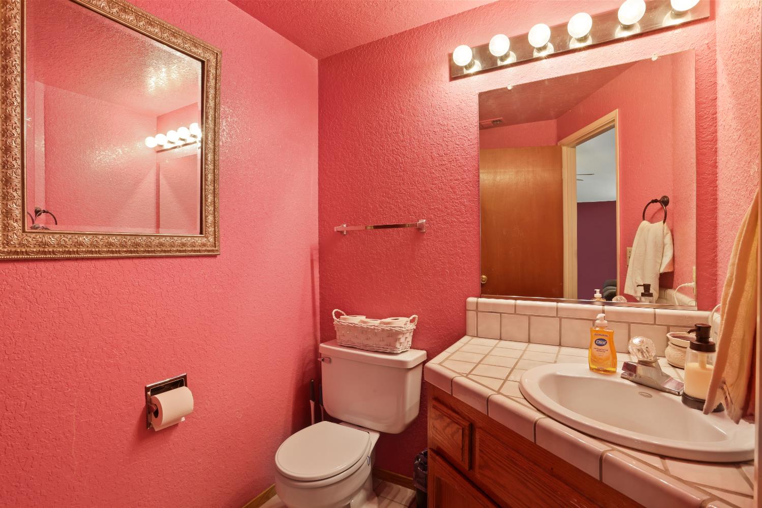 2008 Sheldon Drive Modesto, CA 95350 - Photo 6 of 39 a bathroom with a granite countertop toilet a sink and mirror