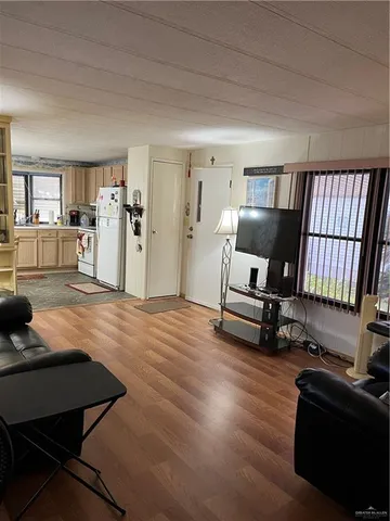 a living room with furniture pool table and chair