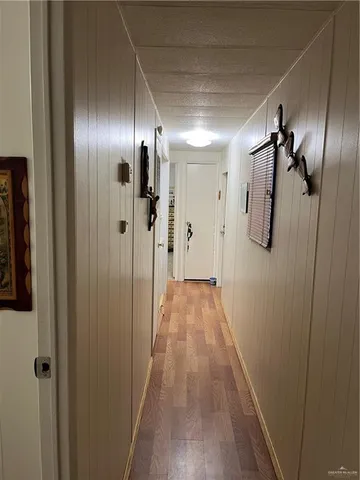a view of hallway with wooden floor