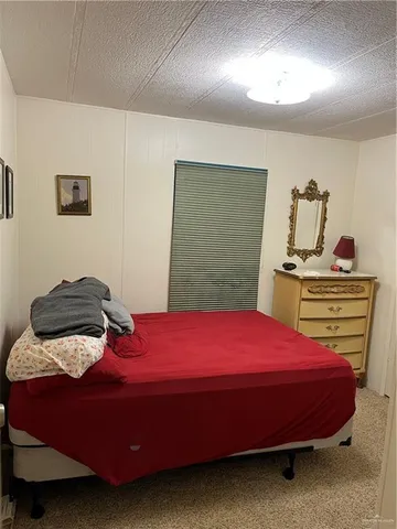 a bedroom with a bed and dresser