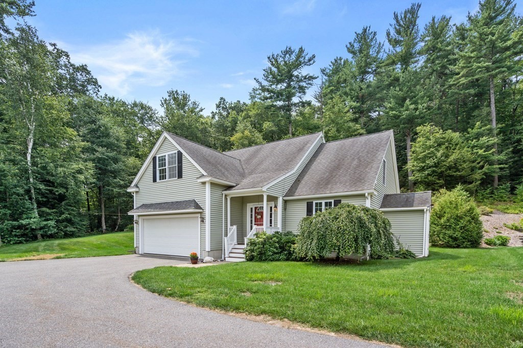 8 Reed Lane, Unit 8 Littleton, MA 01460 - Photo 1 of 37 a front view of a house with a yard and trees