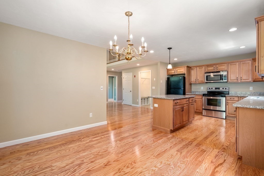 8 Reed Lane, Unit 8 Littleton, MA 01460 - Photo 13 of 37 a view of a kitchen with microwave and cabinets