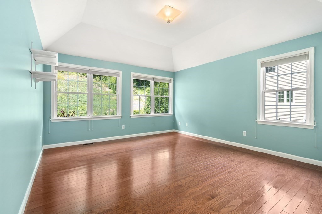 8 Reed Lane, Unit 8 Littleton, MA 01460 - Photo 19 of 37 a view of an empty room with wooden floor and a window