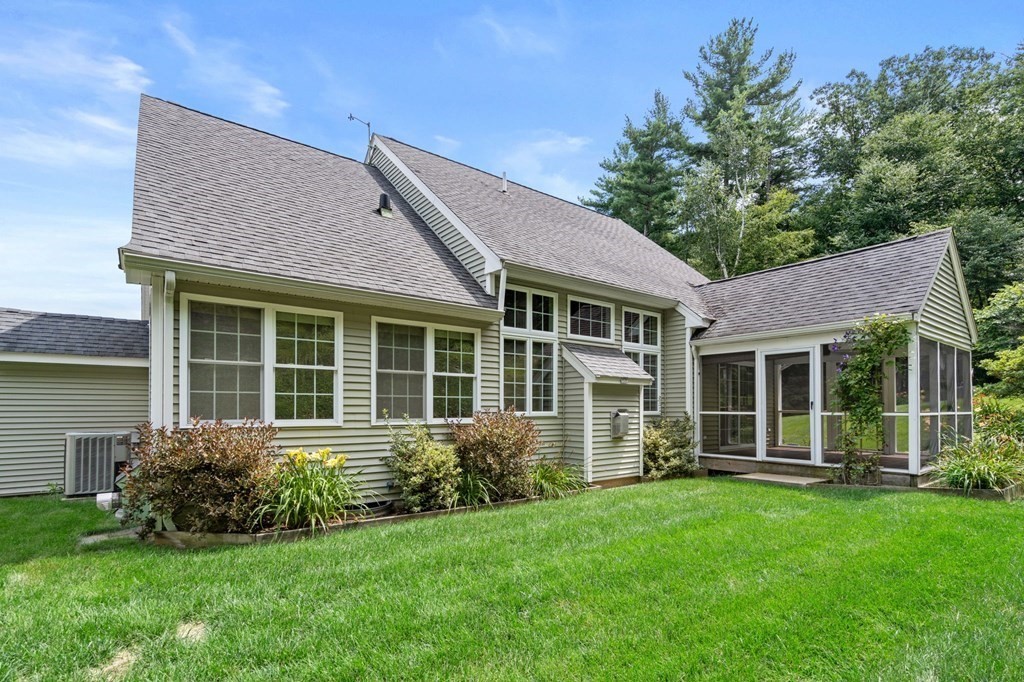 8 Reed Lane, Unit 8 Littleton, MA 01460 - Photo 2 of 37 a view of a house with a garden and plants