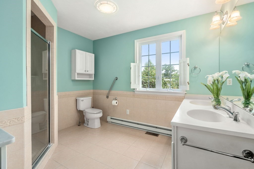 8 Reed Lane, Unit 8 Littleton, MA 01460 - Photo 22 of 37 a bathroom with a toilet sink and mirror