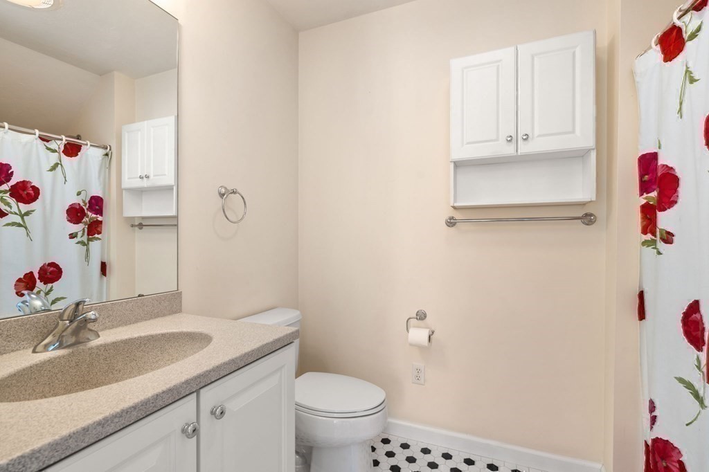 8 Reed Lane, Unit 8 Littleton, MA 01460 - Photo 27 of 37 a bathroom with a sink toilet and vanity