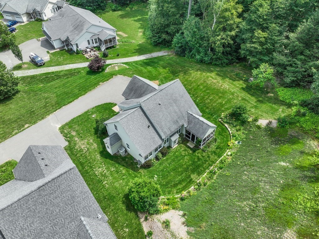 8 Reed Lane, Unit 8 Littleton, MA 01460 - Photo 4 of 37 a view of a garden with an house in front of it