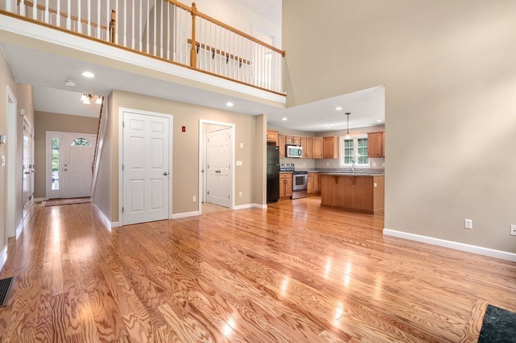 8 Reed Lane, Unit 8 Littleton, MA 01460 - Photo 7 of 37 a view of a hallway with wooden floor