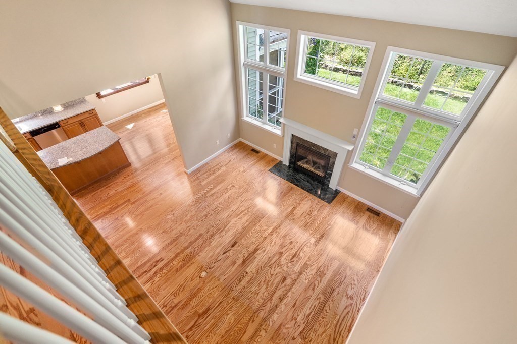 8 Reed Lane, Unit 8 Littleton, MA 01460 - Photo 8 of 37 a view of an empty room with wooden floor and a window