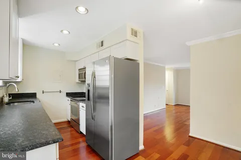 a kitchen with a refrigerator and a sink