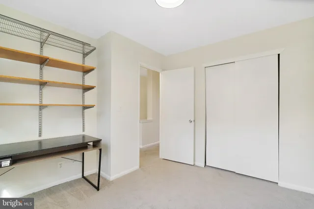 a view of a room with a window and furniture