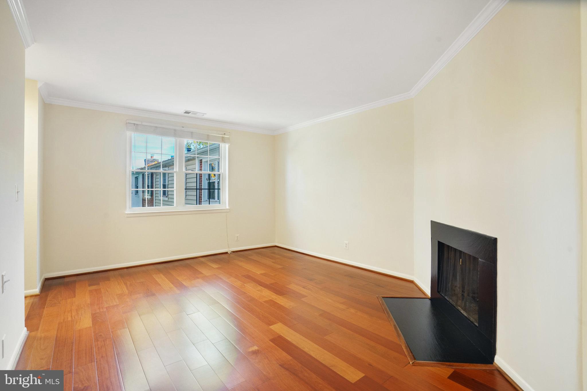4614 28th Road South, Unit B Arlington, VA 22206 - Photo 7 of 27 a view of an empty room with wooden floor and a window
