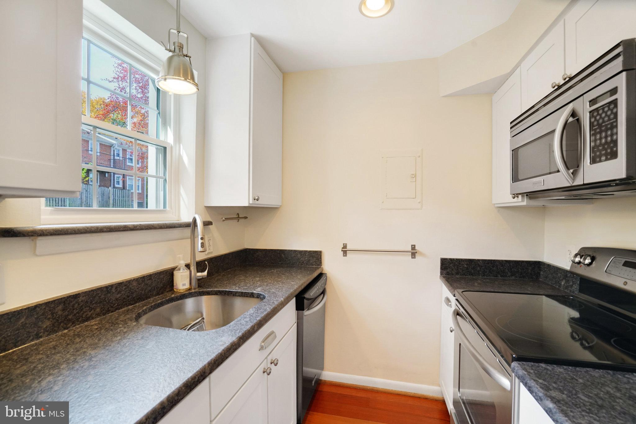 4614 28th Road South, Unit B Arlington, VA 22206 - Photo 8 of 27 a kitchen with granite countertop a sink a stove and cabinets