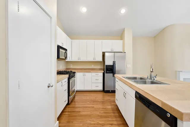 a kitchen with a stove a sink and a refrigerator