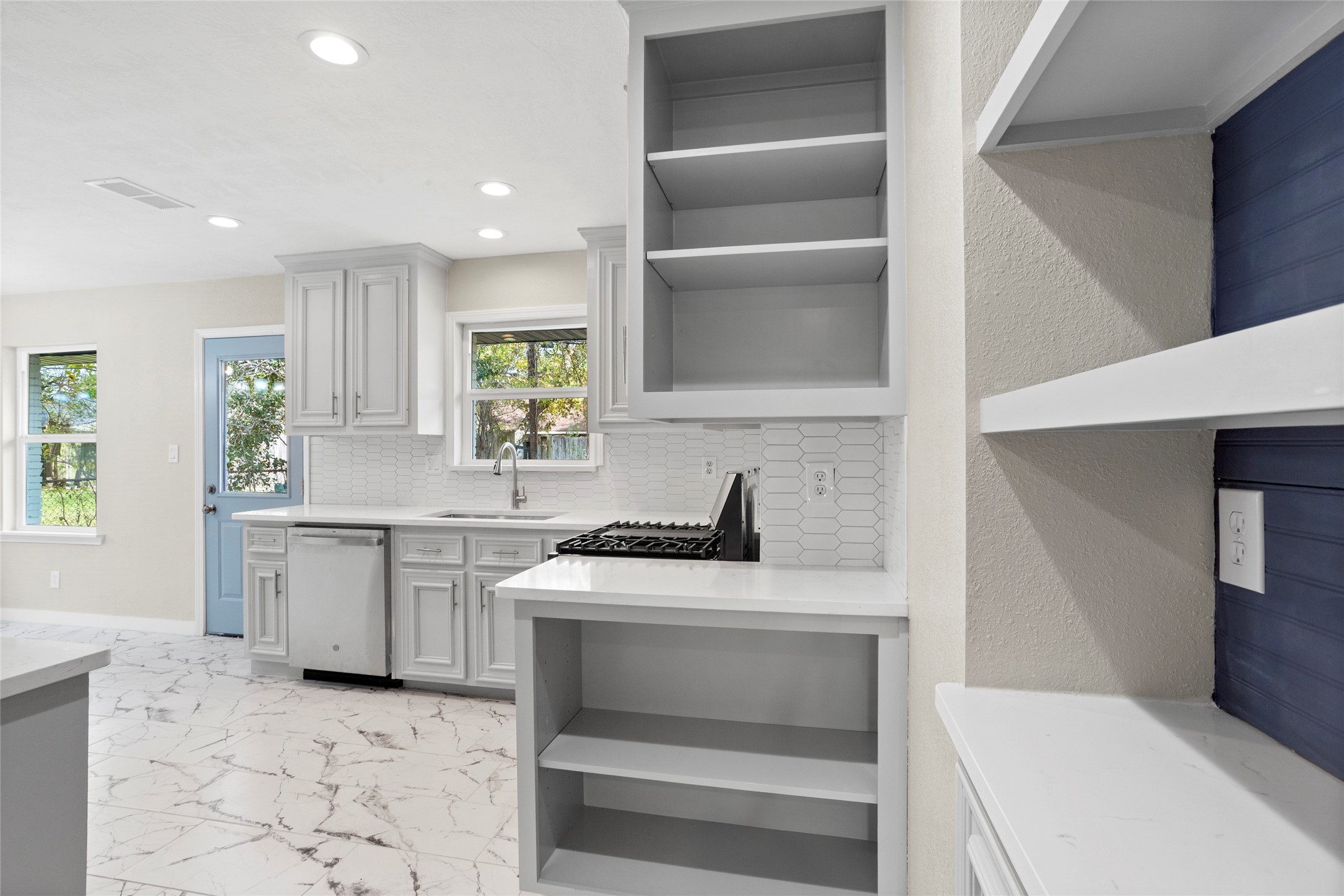10127 Tolman Street Houston, TX 77034 - Photo 8 of 30 a kitchen with a sink stove and cabinets