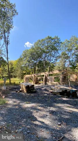a view of a yard with car parked