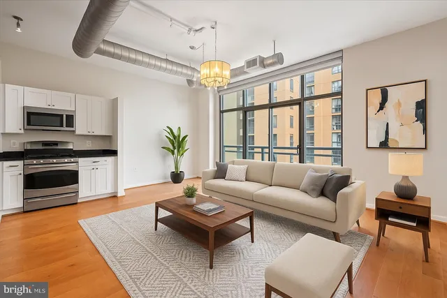 a living room with furniture a dining table and a fireplace