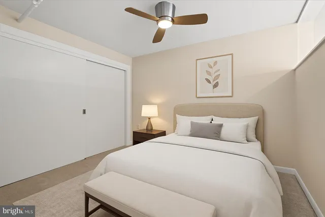 a bedroom with a bed and painting on the wall