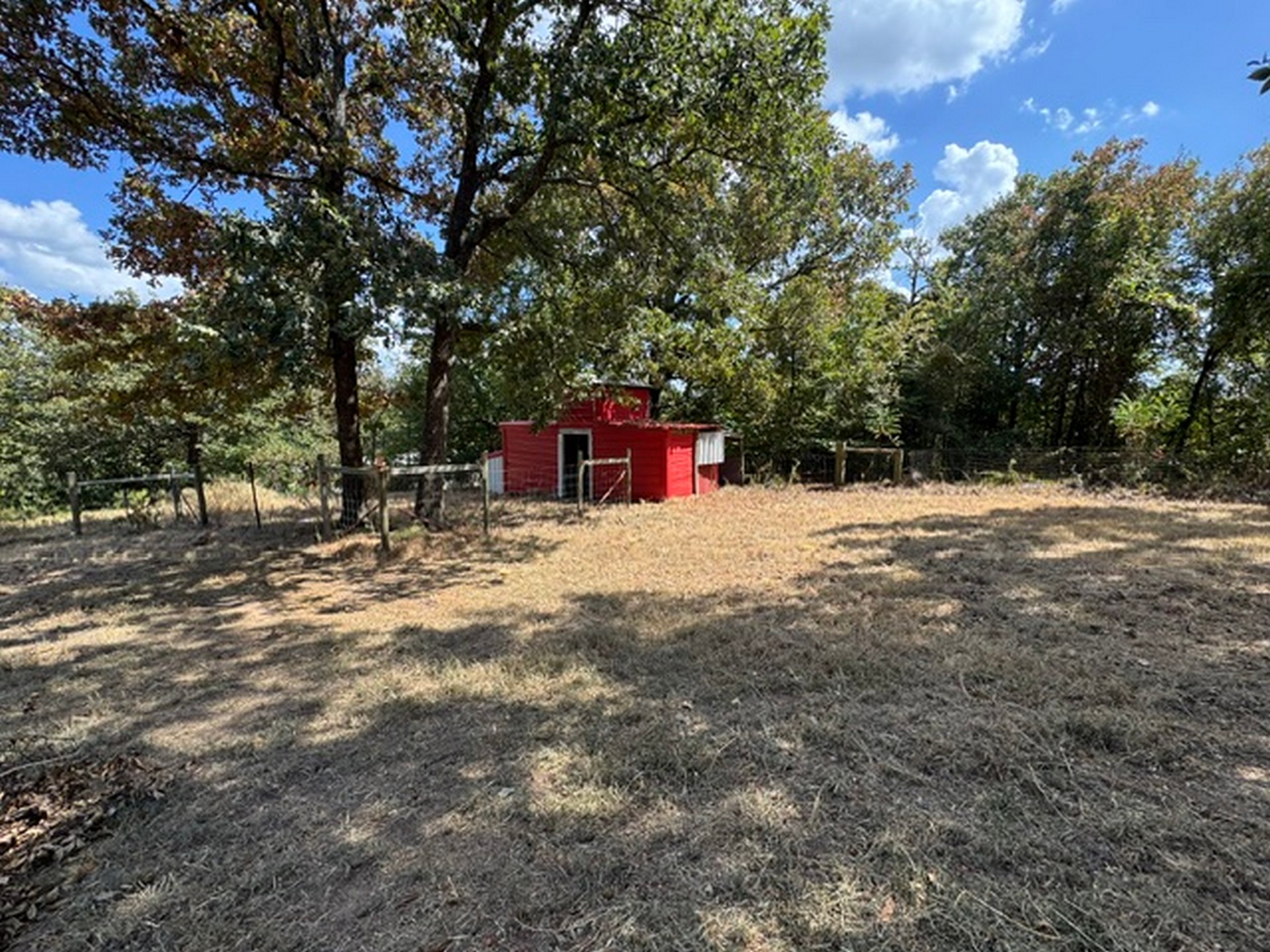 109558 South 4760 Road Muldrow, OK 74948 - Photo 5 of 22 Red outbuilding with a peaked roof, surrounded by a rustic wood fence