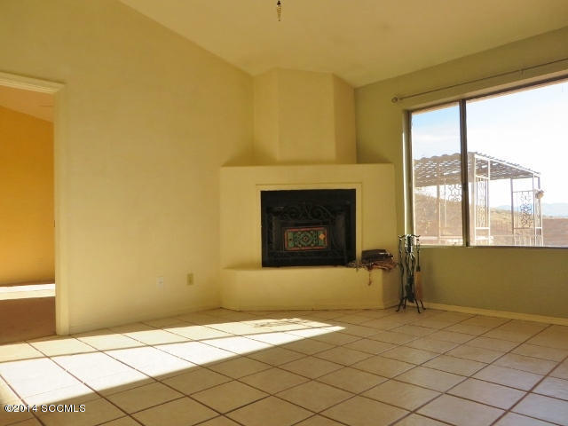 1255 Avenida Gloriosa Rio Rico, AZ 85648 - Photo 28 of 33 a view of empty room with wooden floor and a fireplace