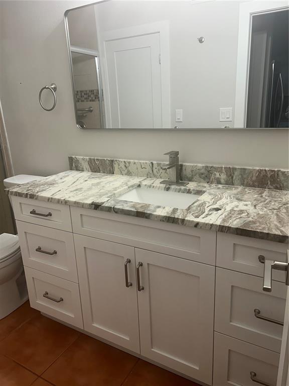 7006 Midnight Pass Road, Unit 1 Sarasota, FL 34242 - Photo 8 of 12 a bathroom with a sink and cabinets