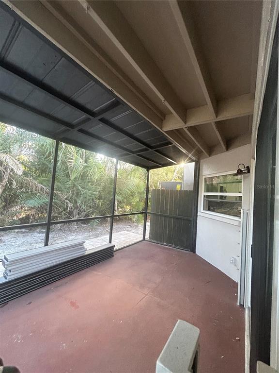 7006 Midnight Pass Road, Unit 1 Sarasota, FL 34242 - Photo 10 of 12 a view of empty room with large windows
