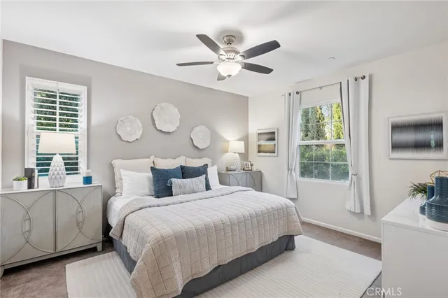 a bedroom with a large bed and a large window