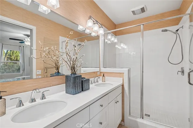 a bathroom with a shower sink and mirror