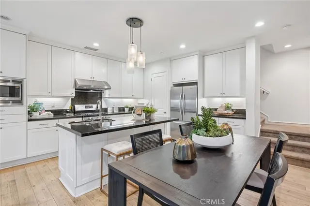 a kitchen with a table and chairs in it