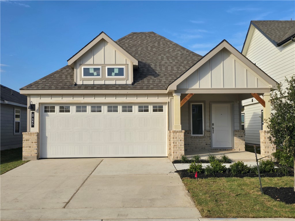 Craftsman inspired home with board and batten siding, covered porch, roof with shingles, and brick siding