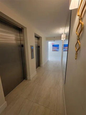 a living room with furniture a rug and a chandelier