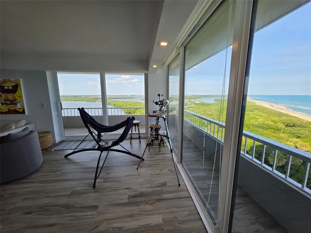 a view of a porch with furniture and wooden floor
