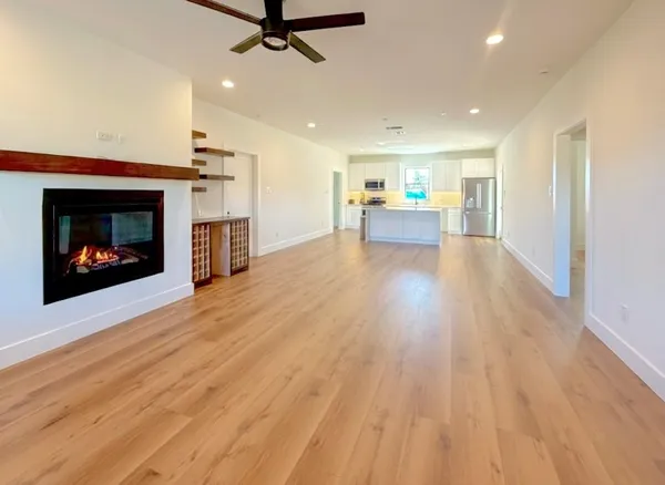 a view of a room with wooden floor