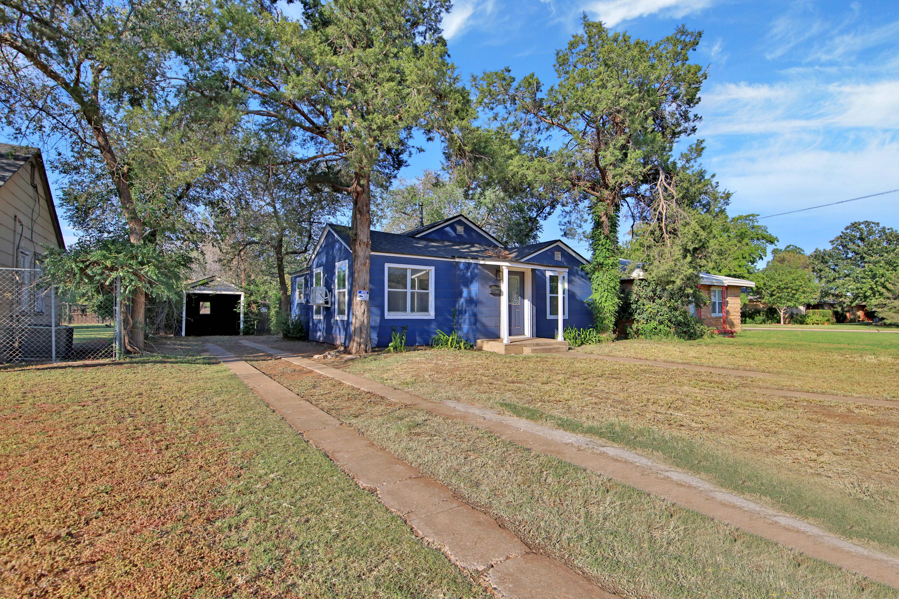 2004 31st Street Lubbock, TX 79411 - Photo 1 of 24 a front view of a house with a yard and trees