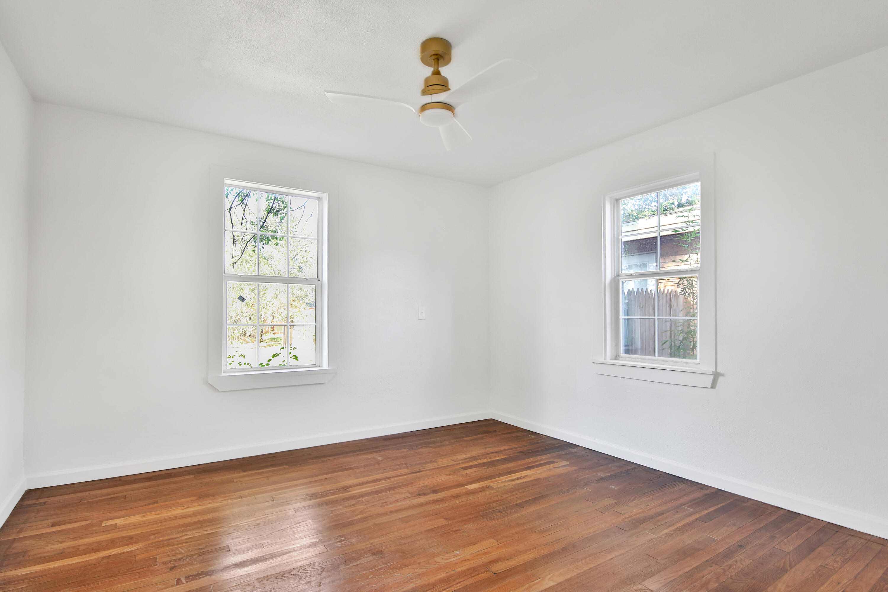 2004 31st Street Lubbock, TX 79411 - Photo 16 of 24 a view of an empty room with wooden floor and a window