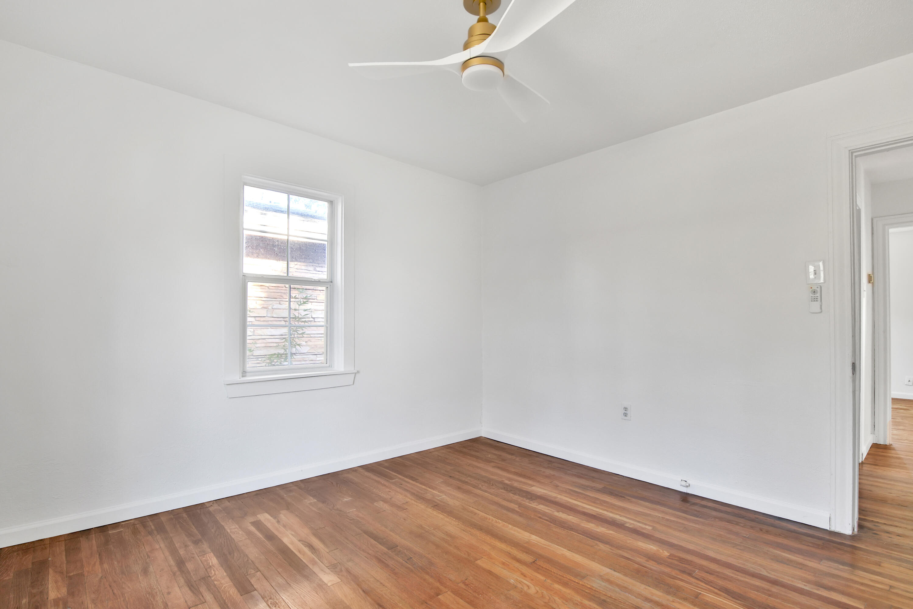 2004 31st Street Lubbock, TX 79411 - Photo 18 of 24 an empty room with wooden floor and windows