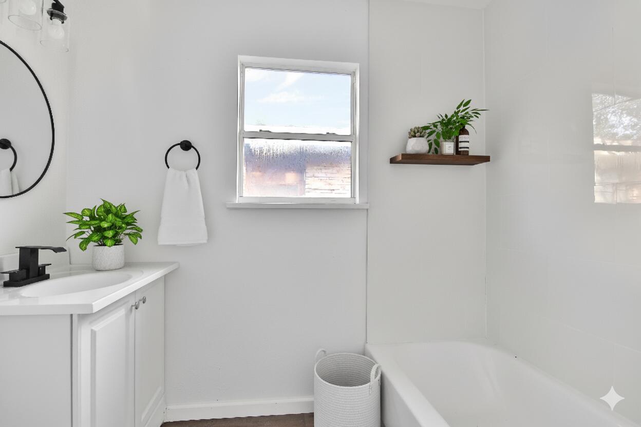 2004 31st Street Lubbock, TX 79411 - Photo 20 of 24 a bath room with a window and a potted plant