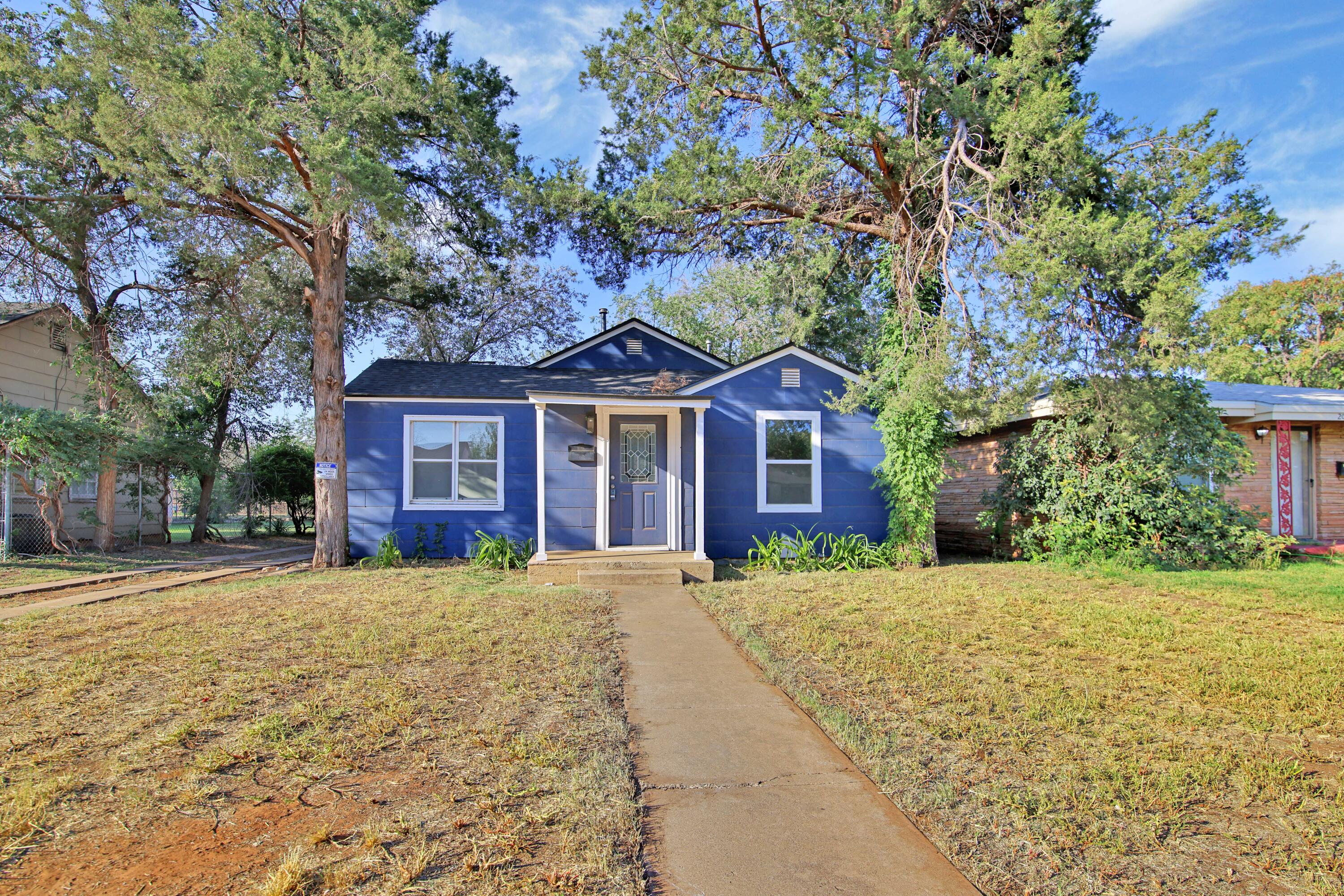 2004 31st Street Lubbock, TX 79411 - Photo 2 of 24 a front view of a house with a yard