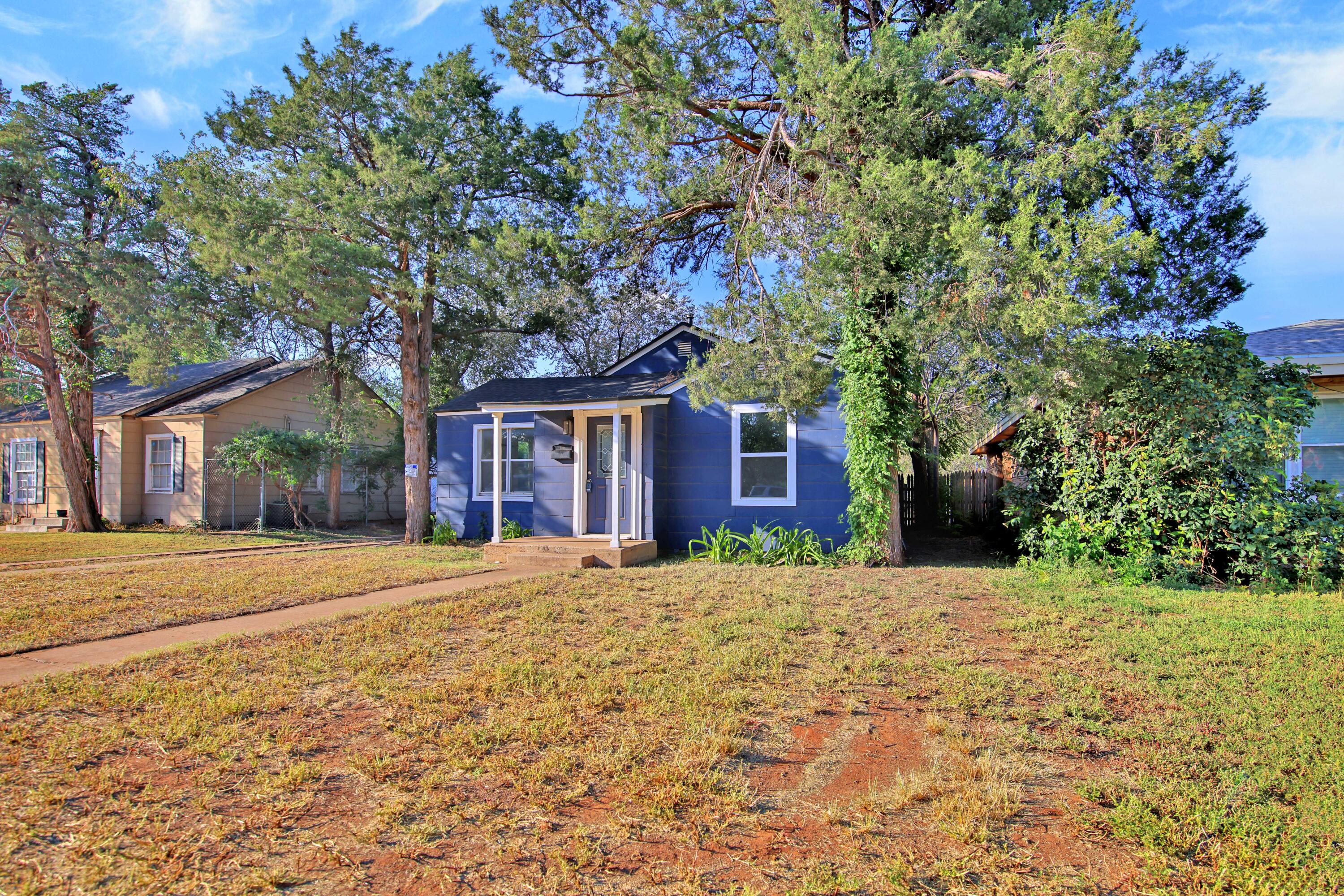 2004 31st Street Lubbock, TX 79411 - Photo 3 of 24 a front view of a house with a garden