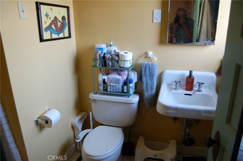 4160 Chestnut Street Riverside, CA 92501 - Photo 17 of 39 a bathroom with a toilet a sink and mirror