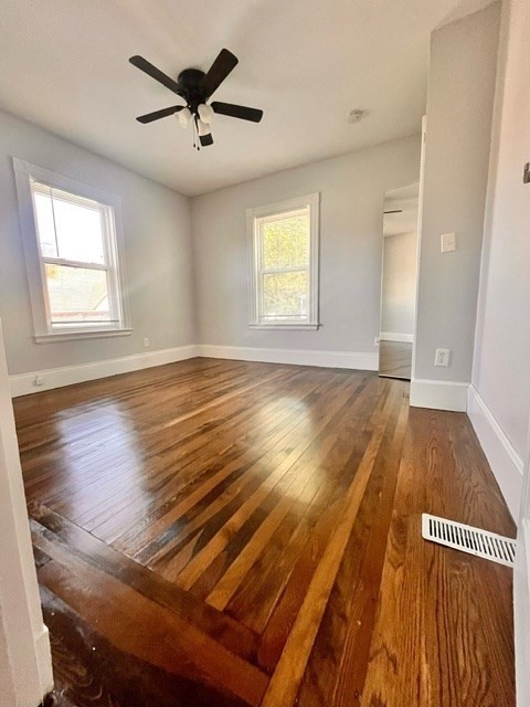686 River Street, Unit 1 Boston, MA 02136 - Photo 5 of 11 wooden floor in an empty room with a window
