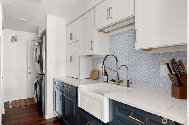 a kitchen with a refrigerator and a sink