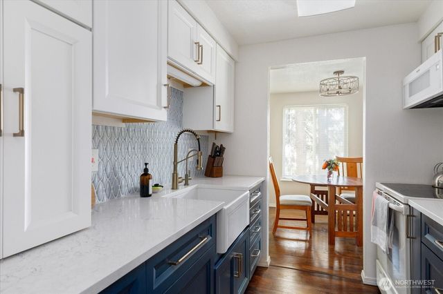 a kitchen with stainless steel appliances a sink and a refrigerator