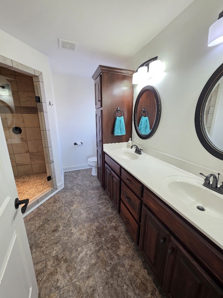 100 Ladybug Lane Bethpage, TN 37022 - Photo 20 of 56 a bathroom with a double vanity sink and a mirror